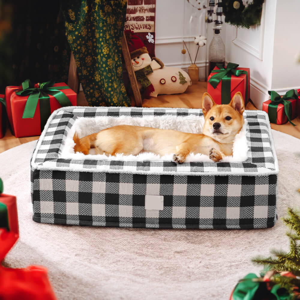 Dog lying on a checkered pet bed with Christmas decorations in the background